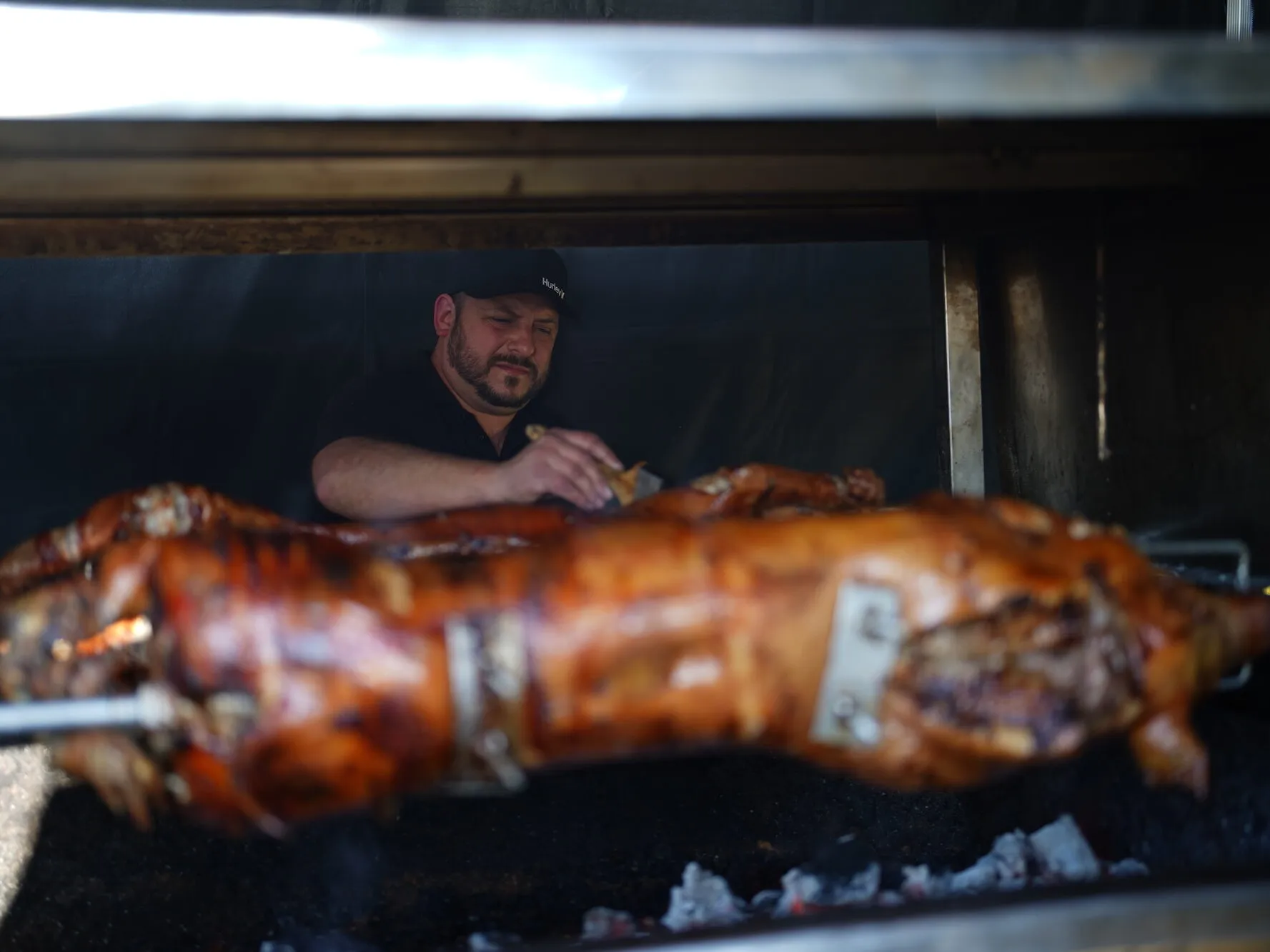 Whole lamb on the spit roast cooked over charcoal