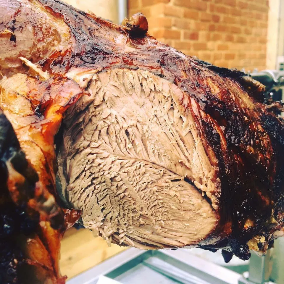 Close-up of meat roasting on a charcoal spit