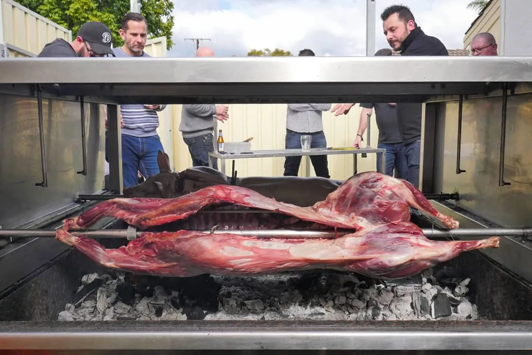 Whole lamb on the spit roast cooked over charcoal
